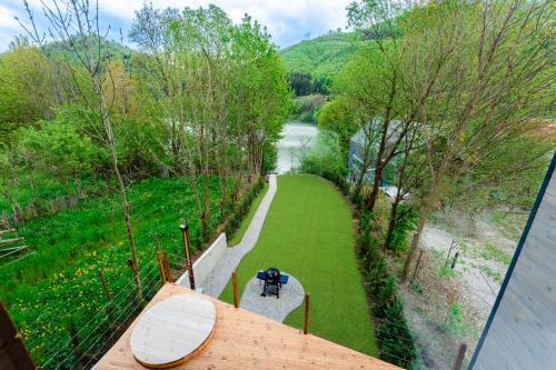 a balcony with a view of a river and trees at Vila ZIA in Teşila