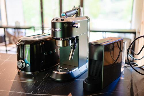 a coffee maker sitting on top of a counter next to a coffee maker at Vila ZIA in Teşila