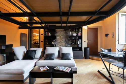 a living room with a couch and a table at Secret Retreat With Lake View by Halldis in Pognana Lario