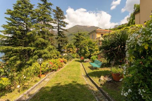a garden with plants and trees and a building at Secret Retreat With Lake View by Halldis in Pognana Lario