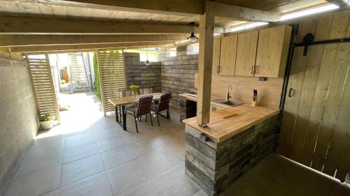 a kitchen with a counter and a table with chairs at Ubytování Tři Vrby in Pasohlávky