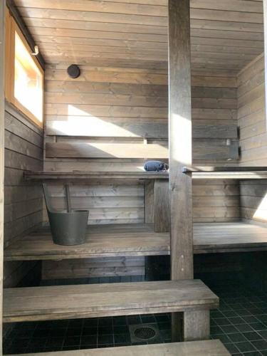 a sauna with wooden walls and benches in a room at Talo Pyhä-Häkin kansallispuiston kupeessa in Saarijärvi
