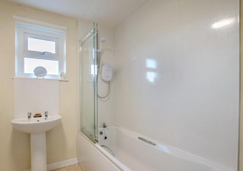 a bathroom with a shower and a sink and a toilet at Bolams Lodge in Ancroft