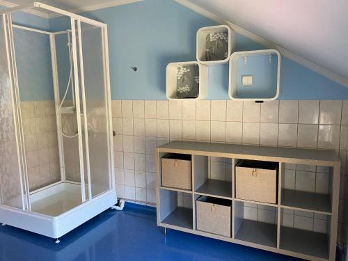a bathroom with a shower and a tv on the wall at Villa Valentina in Lemland