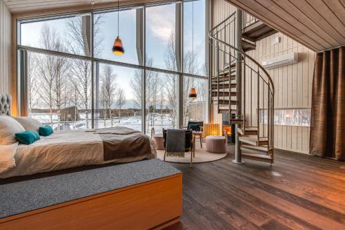 a bedroom with a bed and a large window at Arctic Bath in Harads