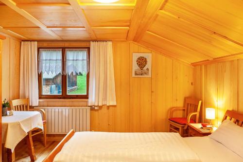 a bedroom with two beds and a table and a window at Ferienhaus Dünser in Bizau