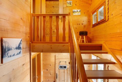 a staircase in a cabin with wooden walls at Ferienhaus Dünser in Bizau