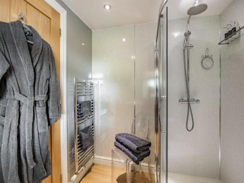 a bathroom with a shower and a glass shower stall at Clay Lake Cottages - Dads Shed in Covenham