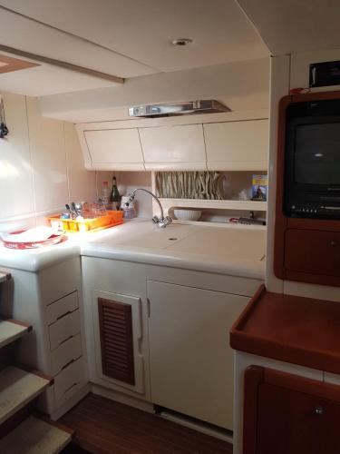 a small kitchen with a sink and a tv at airon marine 42 in Split