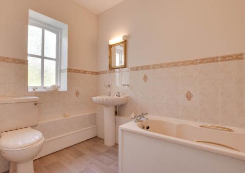 een badkamer met een wastafel, een bad en een toilet bij The Beeches in Frosterley