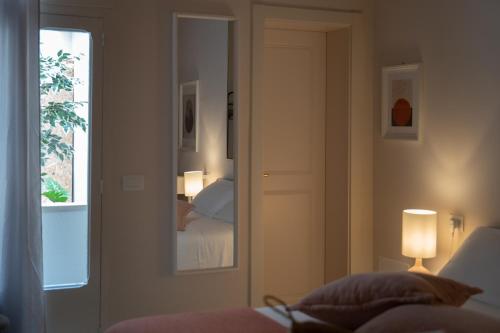 a room with a bedroom with a bed and a mirror at Palazzo Marzionna in Polignano a Mare