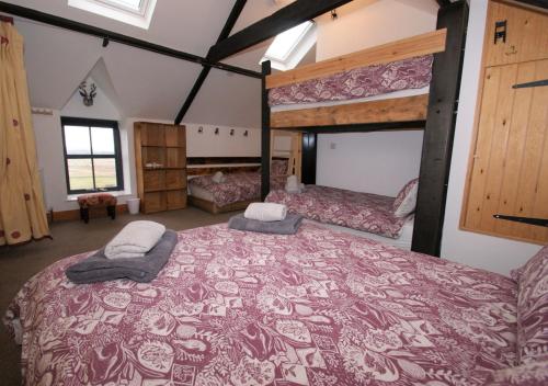 a large room with two bunk beds in it at Little Dod Barn in Ilderton