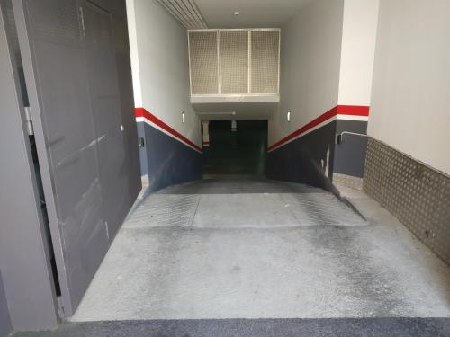 an empty hallway in a building with a door and a tunnel at Hotel Olot Centre in Olot