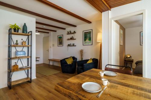 a dining room and living room with a wooden table at Heart of Interlaken Apartments in Interlaken