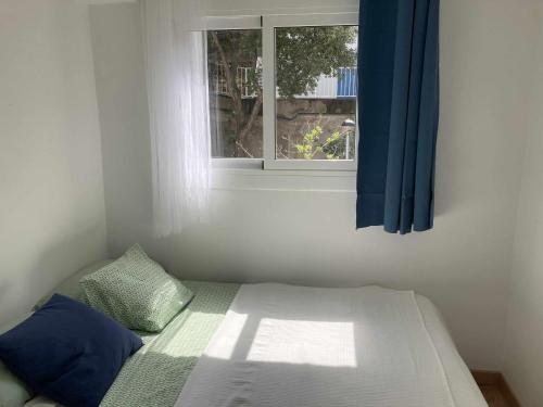 a bed in a room with a window at Espiga, Cala privada Tossa de Mar in Girona
