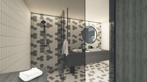 a bathroom with a shower and a sink and a mirror at Dietlgut Natur Resort in Hinterstoder