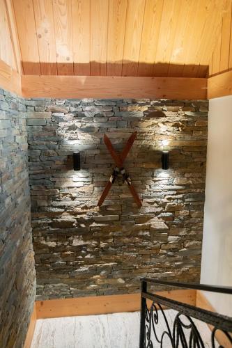 a stone wall with a ceiling fan on a wall at Chocholowska Zohylina pokoje in Chochołów