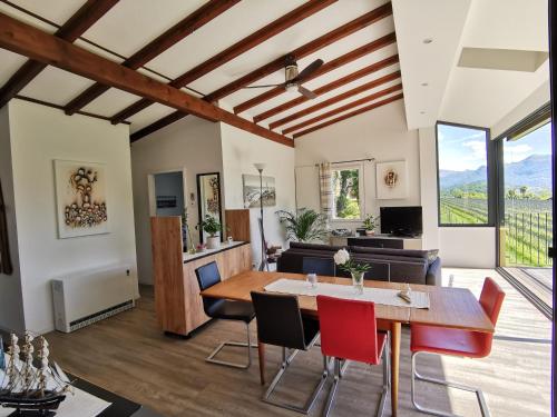 a dining room and living room with a table and chairs at Casa Ghiro in Pura