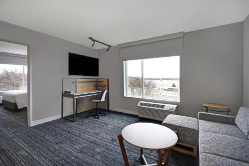 a living room with a couch and a table at TownePlace Suites by Marriott Fall River Westport in Lakeside