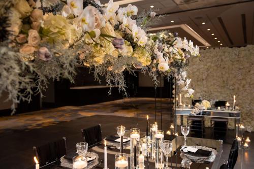 a room with a table with candles and flowers at Sheraton Eatontown Hotel in Eatontown