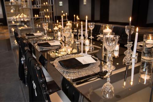 a long table with candles and glasses on it at Sheraton Eatontown Hotel in Eatontown
