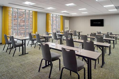 a conference room with tables and chairs and a tv at SpringHill Suites by Marriott Atlanta Northwest in Atlanta