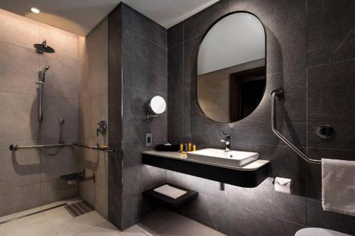 a bathroom with a sink and a mirror at Johannesburg Marriott Hotel Melrose Arch in Johannesburg