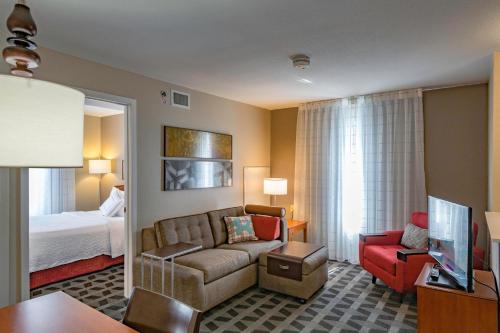 a hotel room with a couch and a bed at TownePlace Suites Cleveland Streetsboro in Streetsboro
