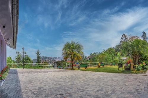 a brick walkway with trees and a park at Summit Barsana Resort & Spa in Kalimpong