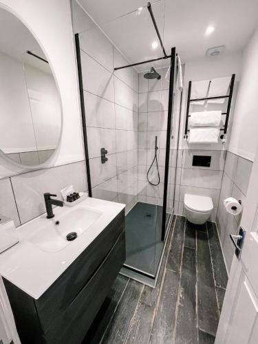 a bathroom with a sink and a shower at Watersmeet Hotel in Woolacombe