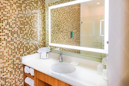 a bathroom with a sink and a mirror at SpringHill Suites by Marriott Houston Baytown in Baytown