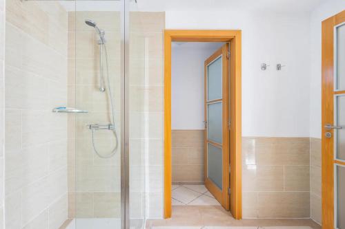 a bathroom with a shower with a glass door at Adosado La Guancha in San Miguel de Abona