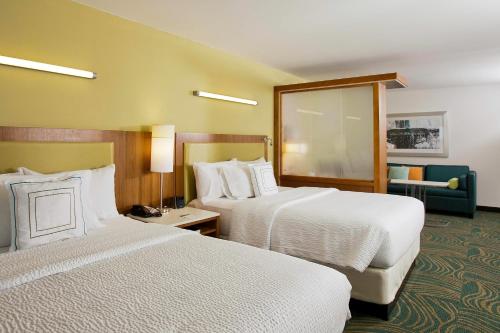 a hotel room with two beds and a couch at SpringHill Suites by Marriott Mobile West in Mobile