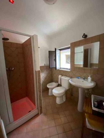 a bathroom with a toilet and a sink and a shower at Antico Borgo - A due passi dalle Gole Alcantara in Motta Camastra
