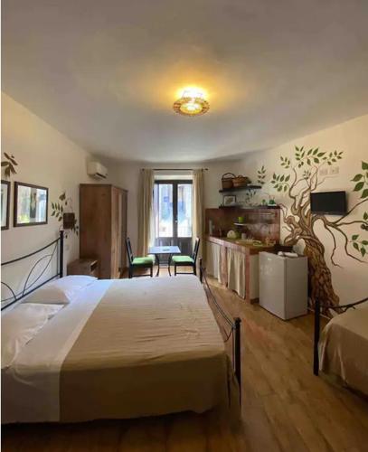 a bedroom with a large bed and a table at Antico Borgo - A due passi dalle Gole Alcantara in Motta Camastra