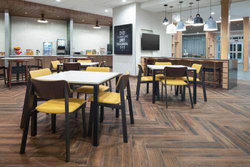 a dining room with tables and chairs in a cafeteria at Fairfield by Marriott Inn & Suites Dallas McKinney in McKinney