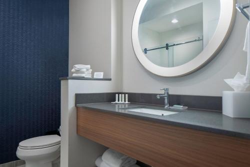 a bathroom with a sink and a mirror at Fairfield by Marriott Inn & Suites Dallas McKinney in McKinney