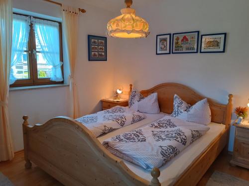 a bedroom with two beds and a chandelier at Sonnenblick in Fischen