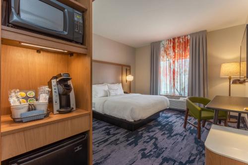 a hotel room with a bed and a television at Fairfield Inn & Suites Franklin in Franklin