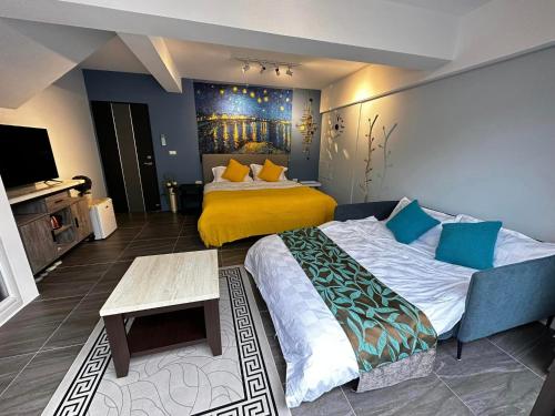 a bedroom with a large bed with a yellow blanket at Kenting - Rest In Your Relax Time in Hengchun