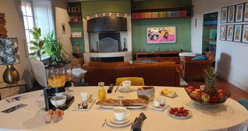 a living room with a table with food on it at Les Cimes du Puy-en-Velay in Le Puy en Velay