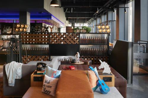 a room with a couch and a table with toys at Moxy Edinburgh Fountainbridge in Edinburgh