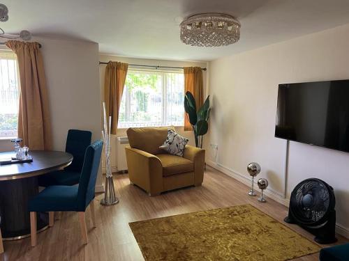 a living room with a couch and a table at Modern Beautiful Gated Two Bed Apartment in Stifford