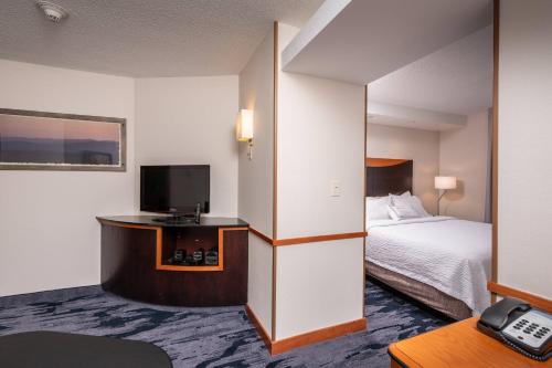 a hotel room with a bed and a television at Fairfield Inn and Suites by Marriott New Bedford in New Bedford