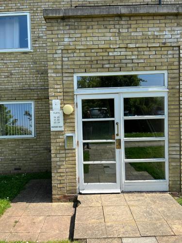 a door to a brick building with at Modern Beautiful Gated Two Bed Apartment in Stifford