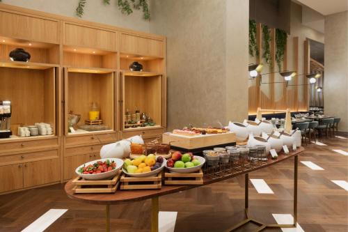 a buffet line with bowls of fruit on a table at The Westin Istanbul Nisantasi in Istanbul