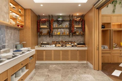 a kitchen with wooden cabinets and shelves with dishes at The Westin Istanbul Nisantasi in Istanbul