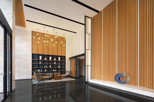 a lobby with a couch and a table and chairs at Fairfield by Marriott Hangzhou Xiaoshan in Hangzhou