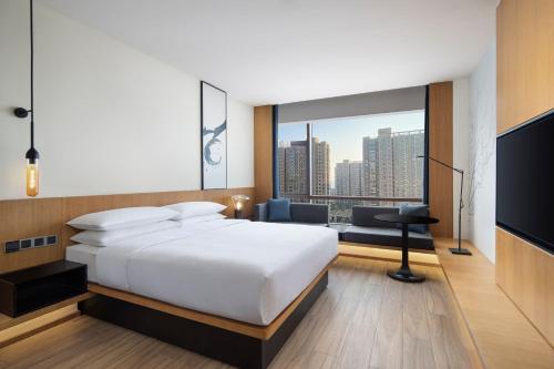 a hotel room with a bed and a large window at Fairfield by Marriott Hangzhou Xiaoshan in Hangzhou