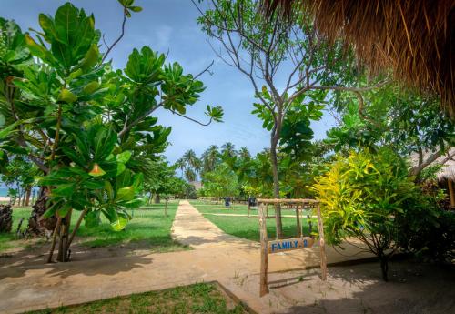 a park with trees and a sign in the middle at Blue Waters in Arugam Bay